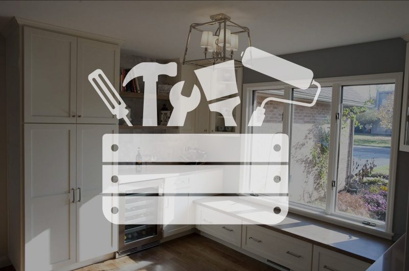 Tool box over an image of a home remodel